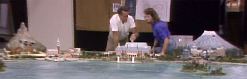 Randy Bright and an unknown second Imagineer examine the American Adventure while flanked by models of the Matterhorn and Mount Fuji.